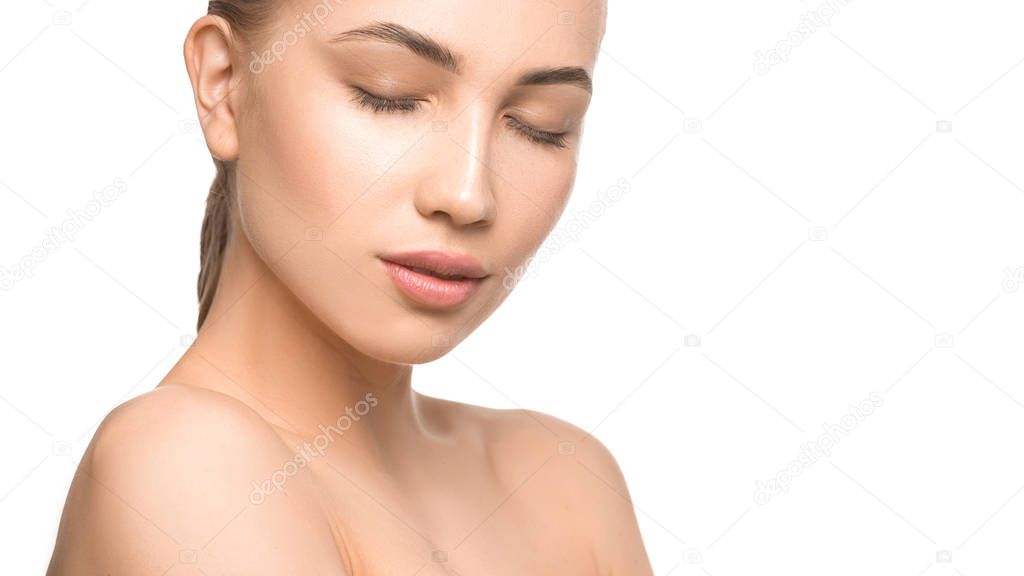 Portrait of beautiful young woman with closed eyes. Pure, natural skin. Isolated on white. Skin care, feminity and woman health concept