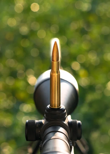 Cartridge on rifle scope. Close up view.