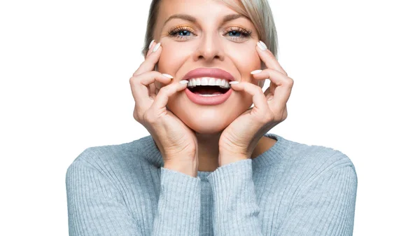 Mujer sonriente con gran sonrisa sobre fondo blanco. Salud dental y concepto de blanqueamiento dental . — Foto de Stock