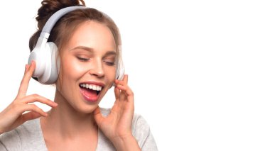 Attractive girl singing with headphones on white background
