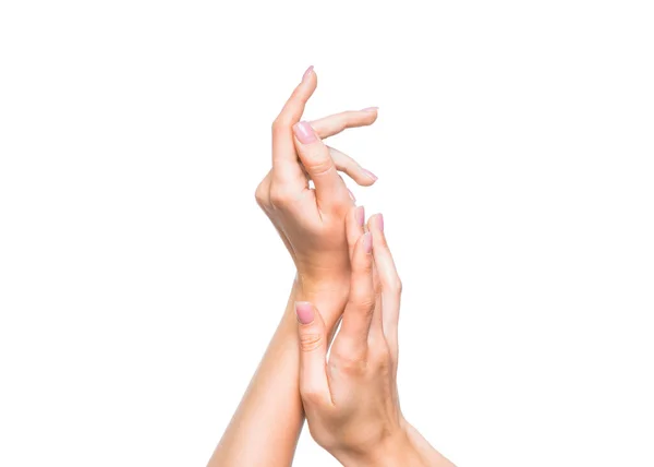 Vrouwelijke handen over witte achtergrond. Crème aanbrengen. — Stockfoto