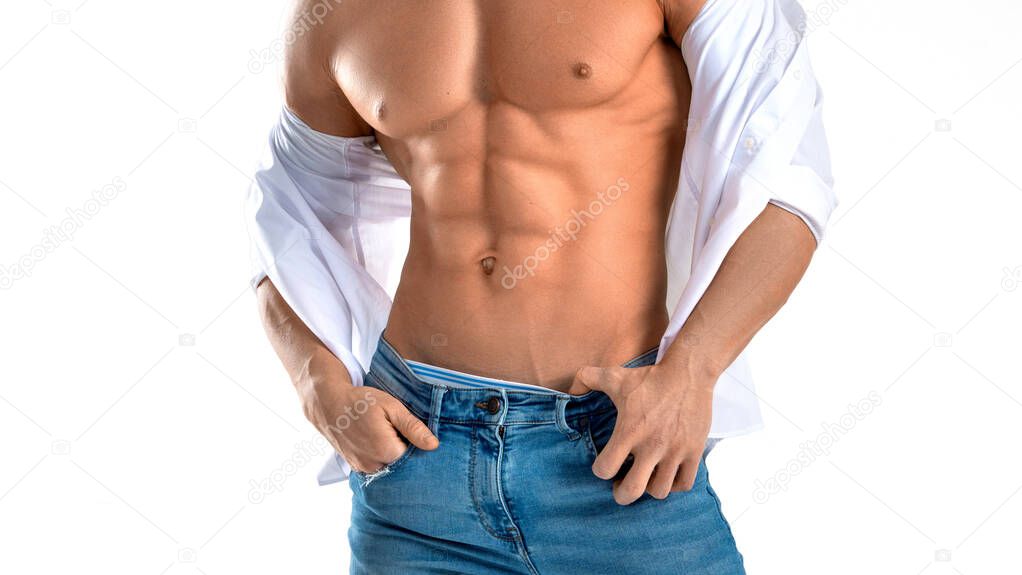 Man in blue jeans with perfect abs. Isolated on white.