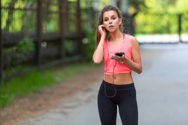 Koşuya çıkmadan önce koşan kadın telefonu ayarlıyor. Sağlık ve aktif yaşam tarzı kavramı.