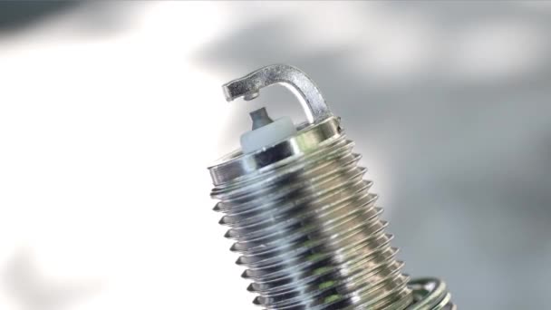 Close-up view of a new spark plug. Rotation — Stock Video