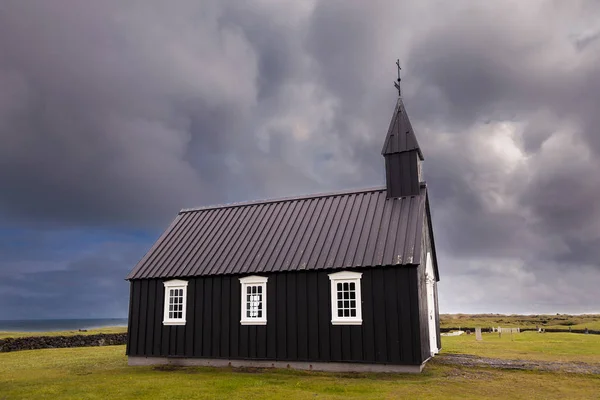 the famous black church of Budir in Iceland. it is the only black church in the whole island