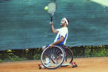 Engelli tenisçi topa forehand bir maç sırasında açık vurur.