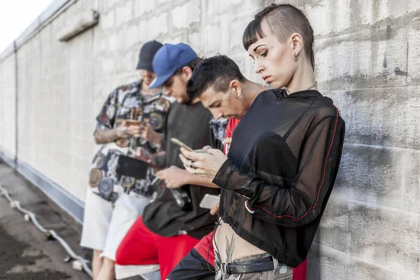 Groep Getatoeëerd Vrienden Met Behulp Van Slimme Telefoon Tegen Een — Stockfoto