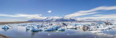 jokulsarlon blue lagoon panorama with icebergs melting in the waters clipart