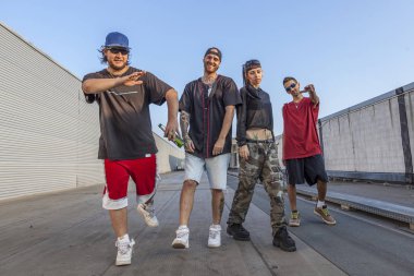 grubu terk edilmiş bir binada metal çatılara poz rapçilerin