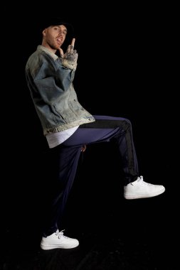 portrait of young rapper in the studio on a black background clipart