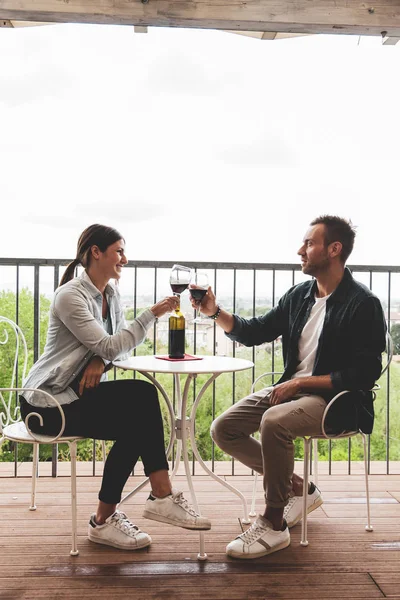 Young loving couple celebrating on the terrace — Stock Photo, Image