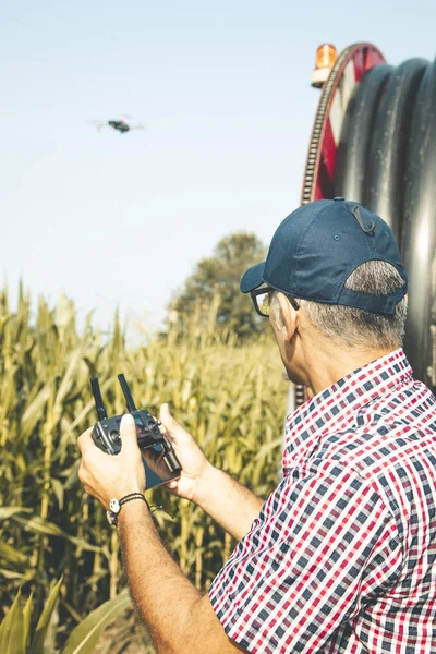 modern technological farmer analyzing the growth of corn by flyi