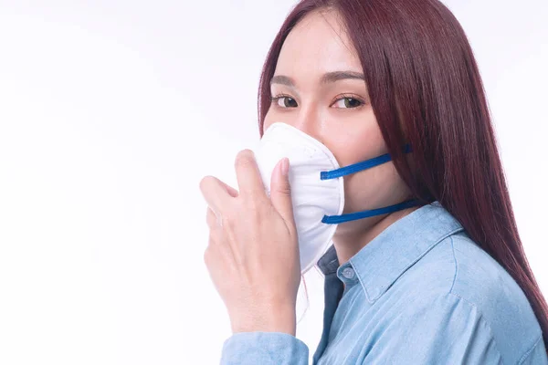 Young women wear face masks to protect disease viruses covid19 and air pollution (PM2.5) or N95 mask safe her healthy problem on isolated white background. Coronavirus and environmental pm2.5 concept.