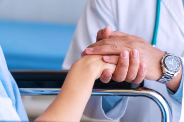 Sabırlı tezahürat ve destek. Kötü haberler azalırken ve destek olurken, kadın doktoru, cesaretlendirmek ve empati kurmak için kadının elini tutuyor. İlaç ve sağlık hizmetleri kavramı.