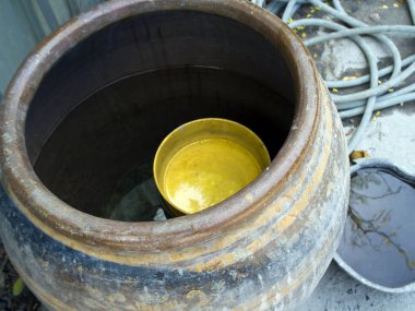 Sarı plastik kase kavanozda yüzüyor.