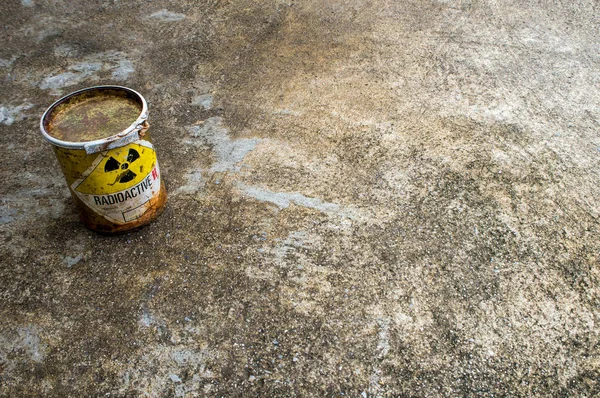 Rusty package of radioactive material container on the floor