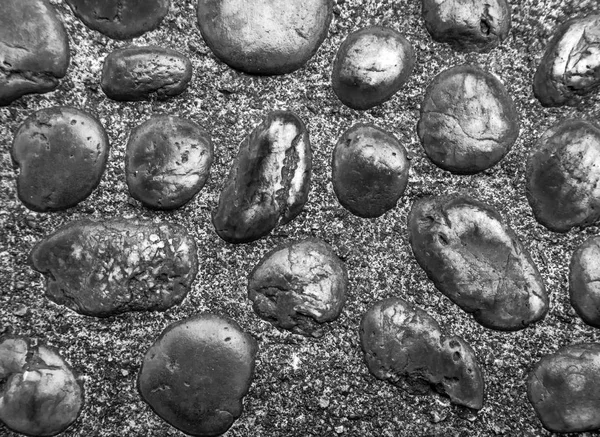 Texture of river stone in concrete walkway