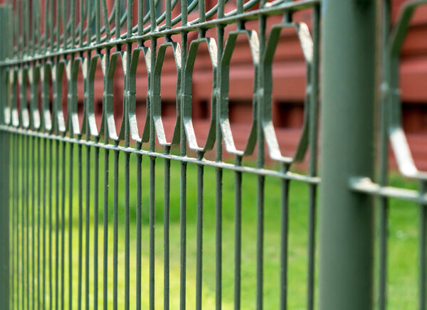 Wrought iron fence beside a street in the city