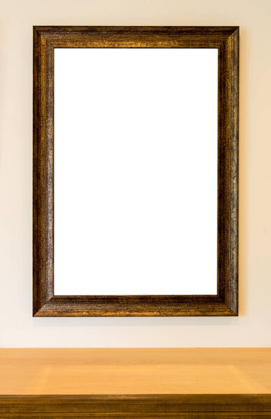 The blank wooden picture frame on the wall over the wooden shelf