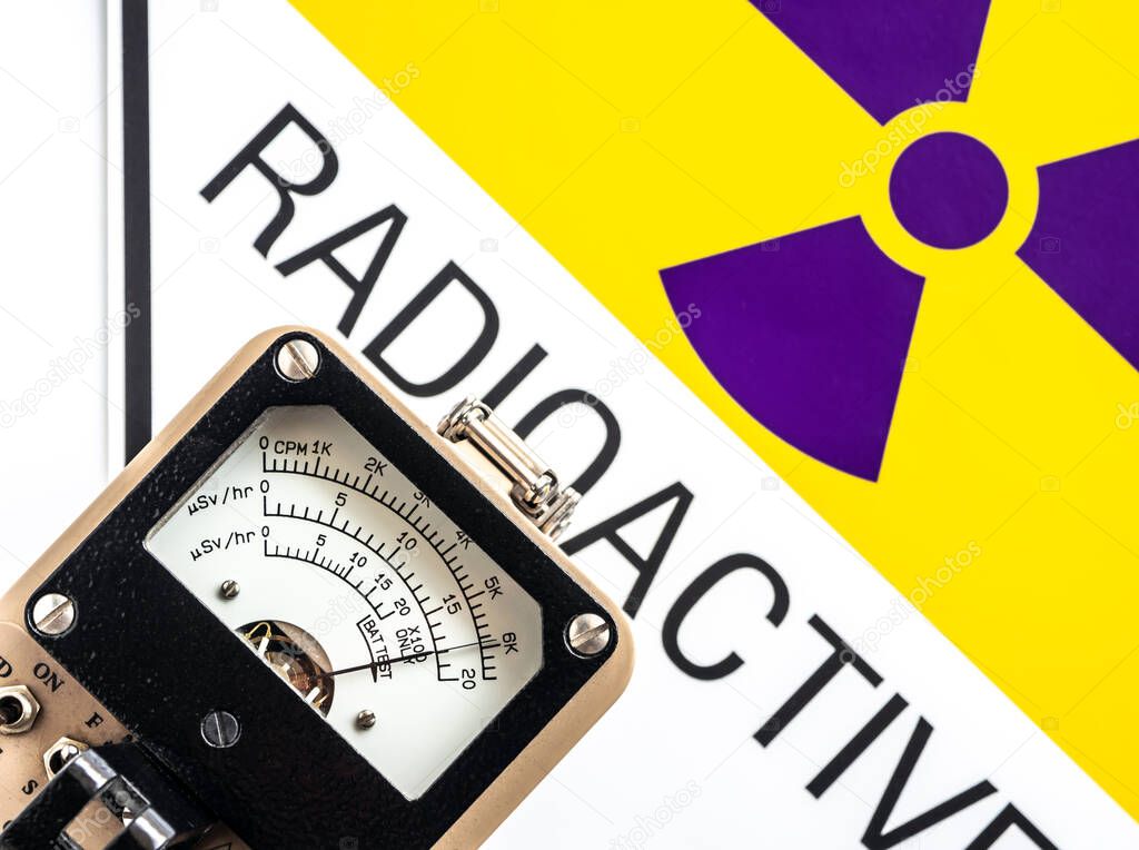 Hand-held radiation survey instrument detecting at the radioactive material symbol on label