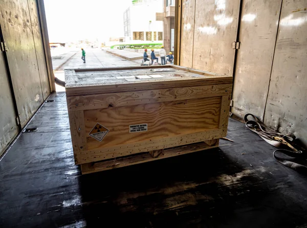 Radioactive material label beside the transportation wooden box Type A standard package in the truck