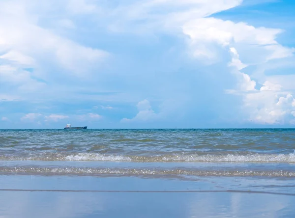 Far away from the coast the big ship still floating alone in the silent sea, cloudy and calm sky