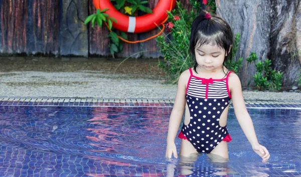 Cute asian female toddler child while playing with water on a sw — Stock Photo, Image
