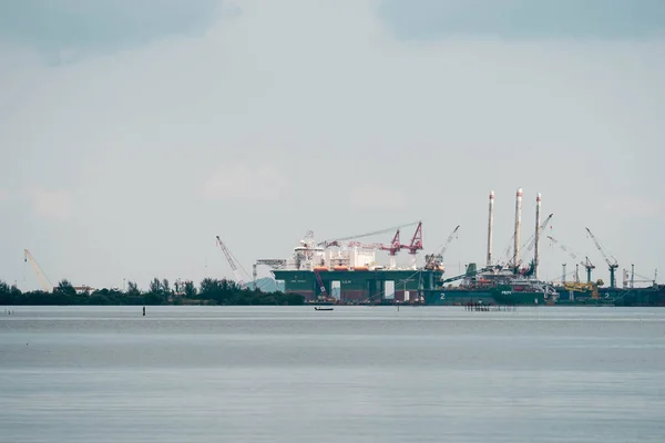 Oil and gas refinery plant near a beach in Batam Indonesia Stock Photo