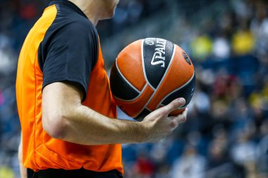 Berlin, Germany, October 04, 2019: a referee holds the official basket game ball during a Turkish Airlines EuroLeague match between Alba Berlin and Zenit St Petersburg at Mercedes Benz Arena in Berlin. clipart