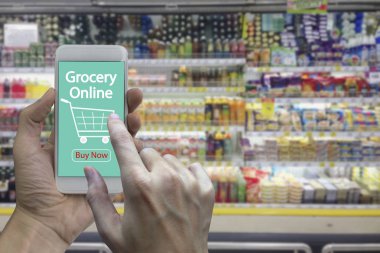 Bulanık süpermarket ve perakende mağaza alışveriş merkezi iç arka planda kullanım smartphone ekranında bakkal online ile teslim.