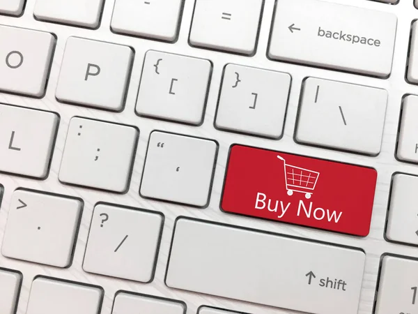 Computer keyboard enter button with Buy Now and Shopping cart symbol.