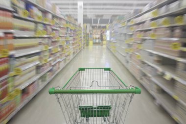 Süpermarket koridor boş alışveriş sepeti ile süpermarket mağaza alışveriş sepeti ile bulanık arka plan.