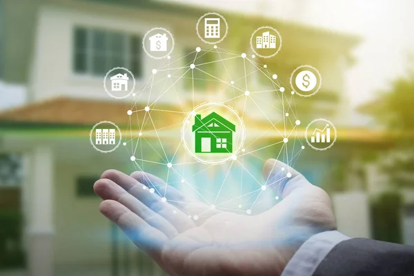 Hand holding with property investment Icons over the Network connection on property background, Property investment concept.