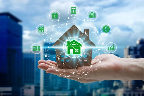Hand holding with property investment icons over the Network connection on property background, Property investment concept