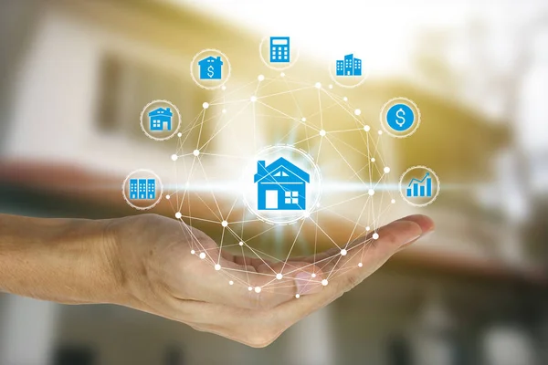 Hand holding with property investment icons over the Network connection on property background, Property investment concept