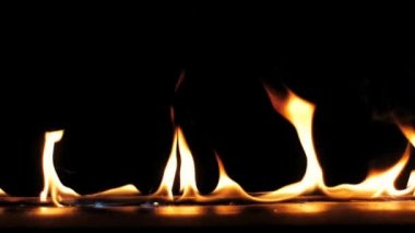 Tutuşabilme ve yanma - Slow Motion alevler ateş. Gerçek alevlerin bir çizgi üzerinde siyah bir arka plan tutuşturmak. Herhangi bir yangında harika görünüyorsun veya proje ızgara olacak. Gerçek yangın. 