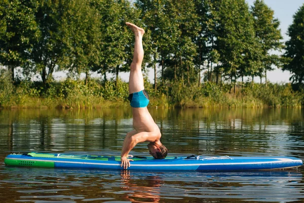 Yoga on a SUP Board, exercises on the water,