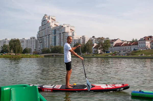 Minsk, Bielorrusia-8 de septiembre de 2018: el surfista con tablas de pádel de pie, flotando en el río. el concepto de deportes y personas, estilo de vida activo, recreación acuática , — Foto de Stock