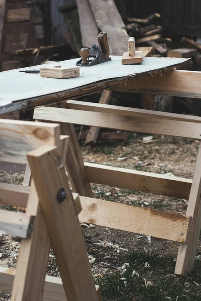 Old carpentry tools. Carpenters workplace outdoor, carpenters tools on wooden table,