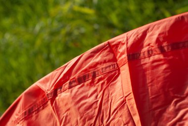 red tent close-up, durable material of long-lasting tourist equipment and sportswear clipart