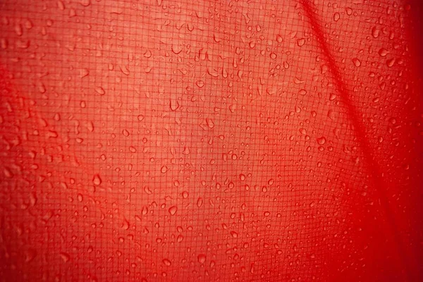 red tent close-up, strong and durable material of long-lasting tourist equipment and sportswear