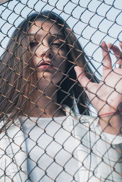 Girl holding hand on metal chain wire mesh, concept of abuse of women human trafficking, crime and domestic violence, — Stock Photo, Image