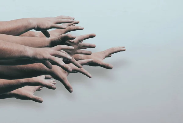 Lots of zombie hands on light background. Hands will reach out. The concept of discounts on the day of black Friday,