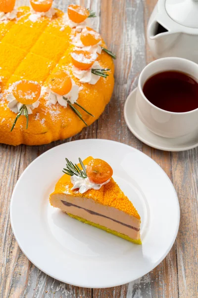 Advertisement and menu photo of velvet orange cake with tea on light wooden background