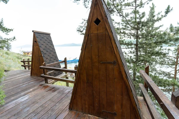 Small wooden triangle hut for meditation on Baikal Lake, meditation spot on russian north