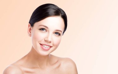 Güzel gülümseme ile genç kadın güzellik portresi. Boş alan ile nötr arka plan