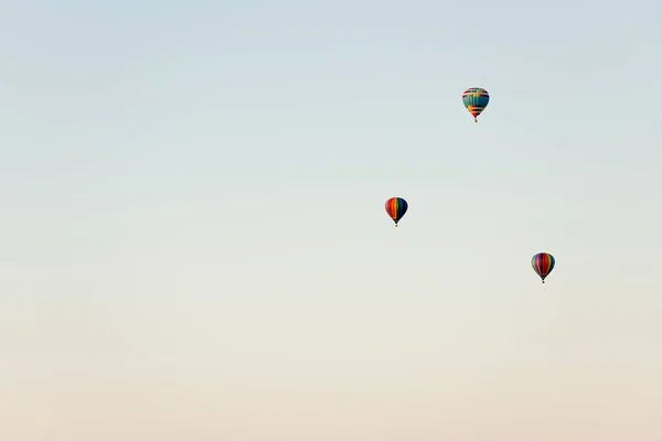 Flying in a balloon. Three objects in the air against the cloudless sky