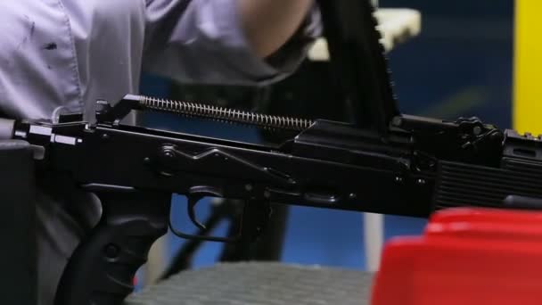 Weapon inspection. Female worker checks the weapons for defects. Close up view — Stock Video