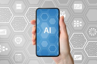 AI / yapay zeka kavramı. Modern çerçevesiz smartphone simgeleri ile nötr arka plan önünde tutan el 