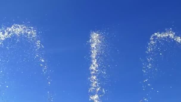 Вершини водяних струменів, що стикаються вгору на блакитне небо — стокове відео